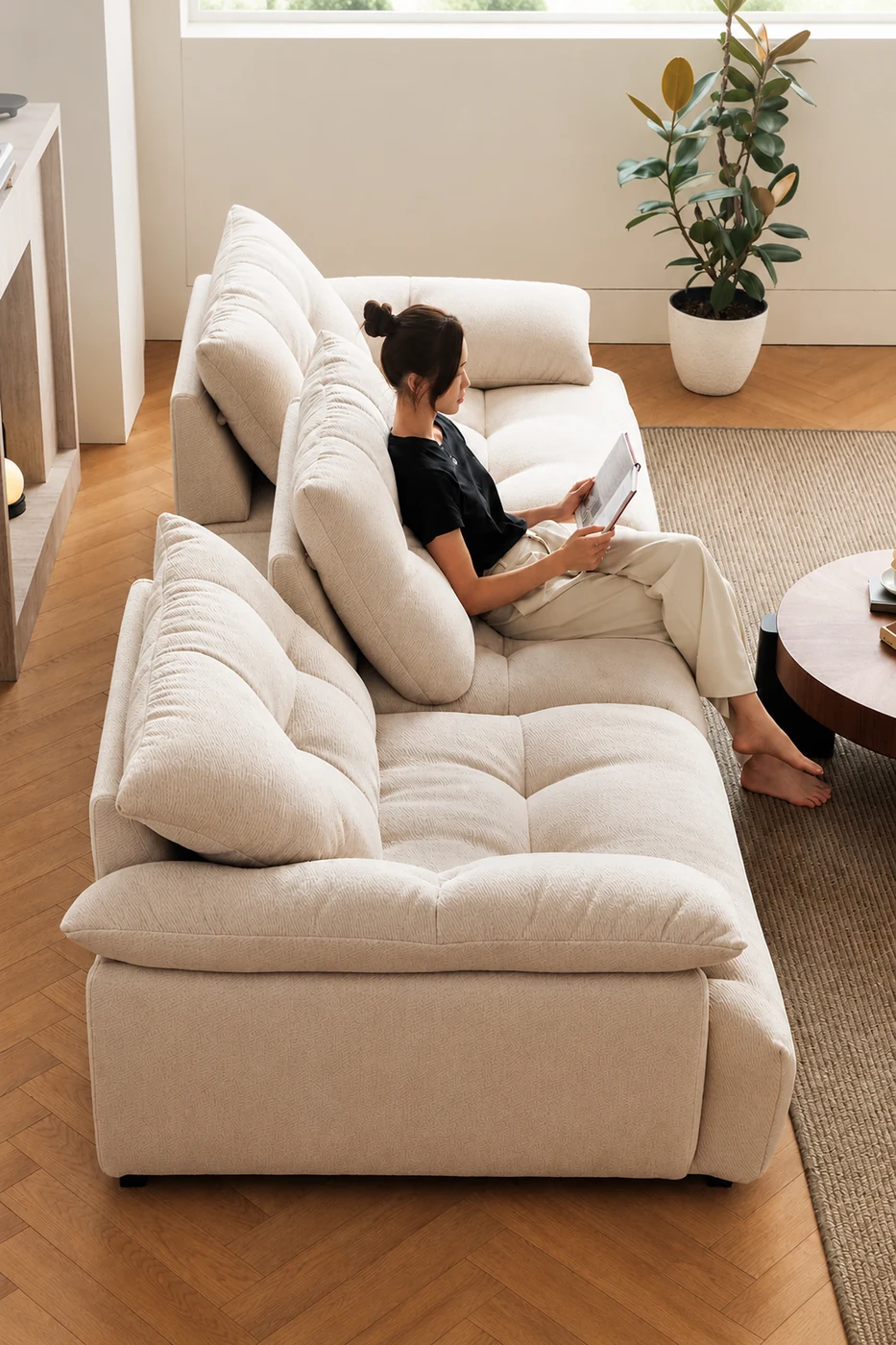 Modular sectional sofa with a person relaxing on the deep seat