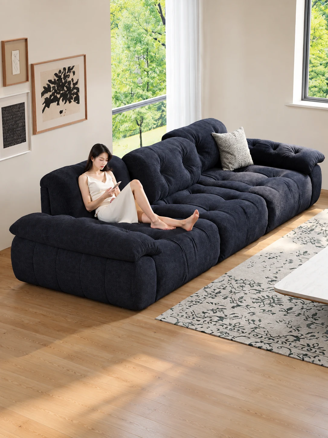 A person relaxing on the navy blue snow velvet modular sofa