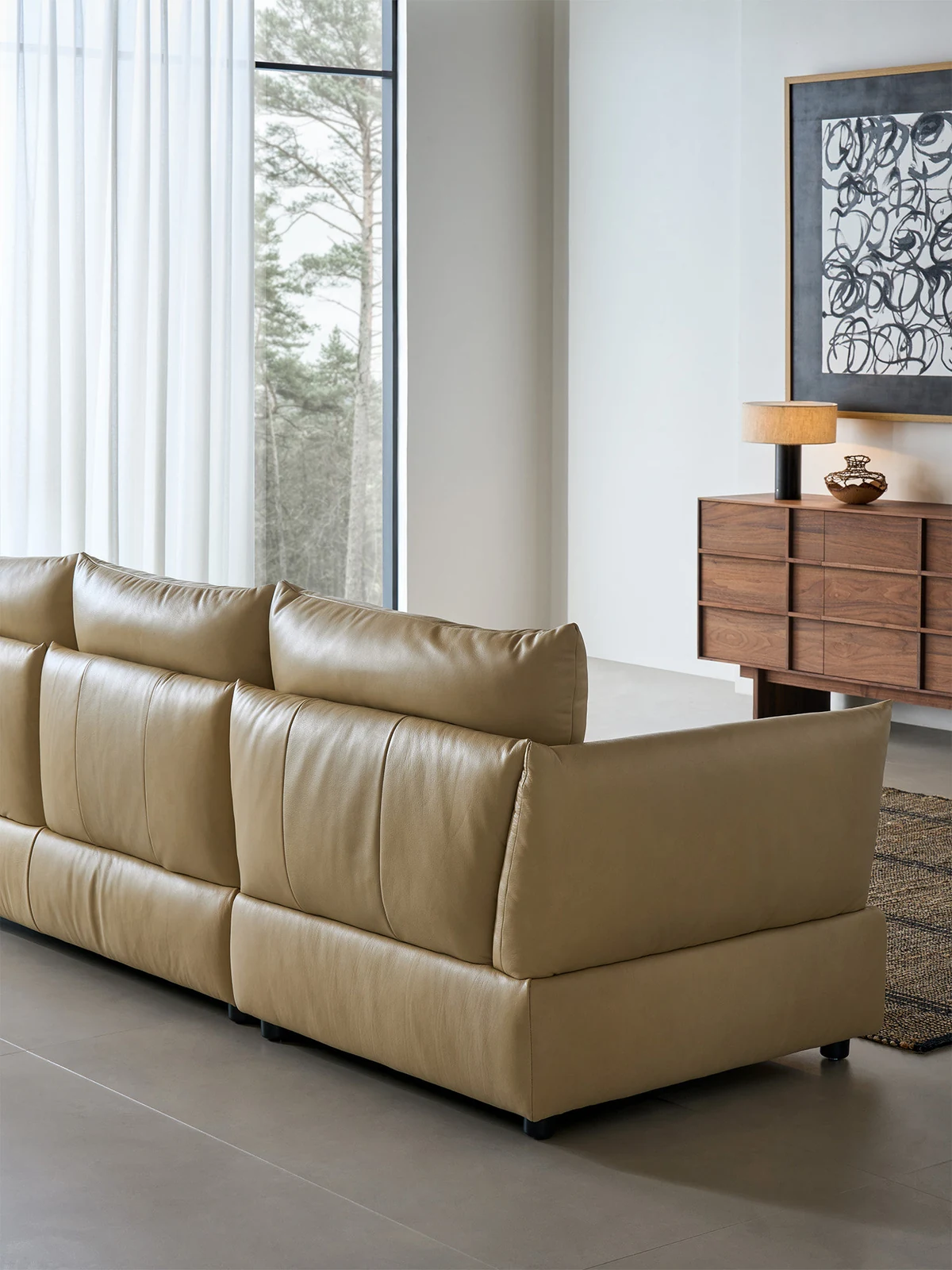 Full-grain leather sofa in a living room with a sideboard