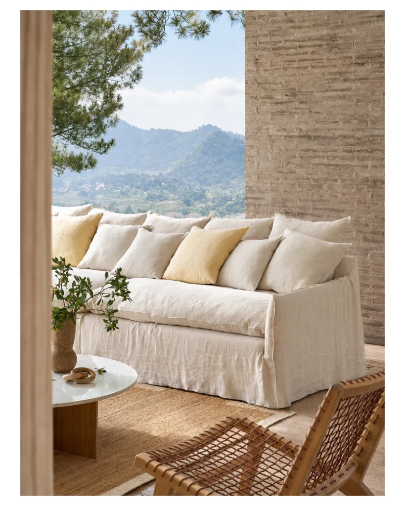 Oatmeal linen slipcover sofa with down-filled cushions in a bright living room