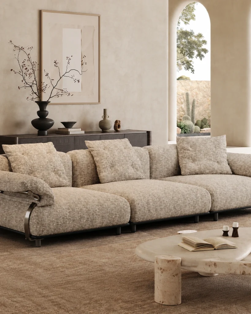 Oatmeal cotton-linen modular sofa with a black stainless steel base in a warm plaster interior