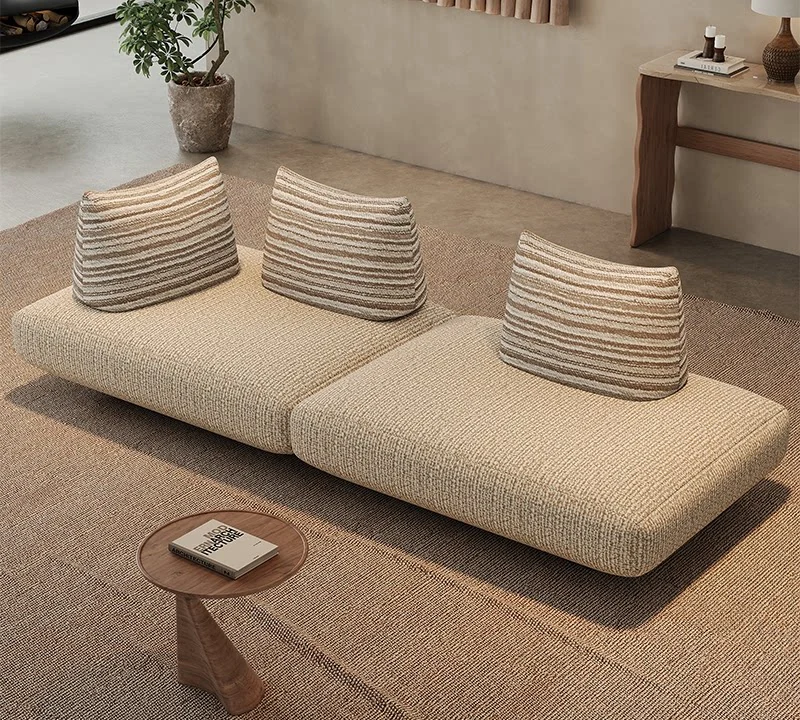 Free-form modular sofa arranged as two seats with a side table