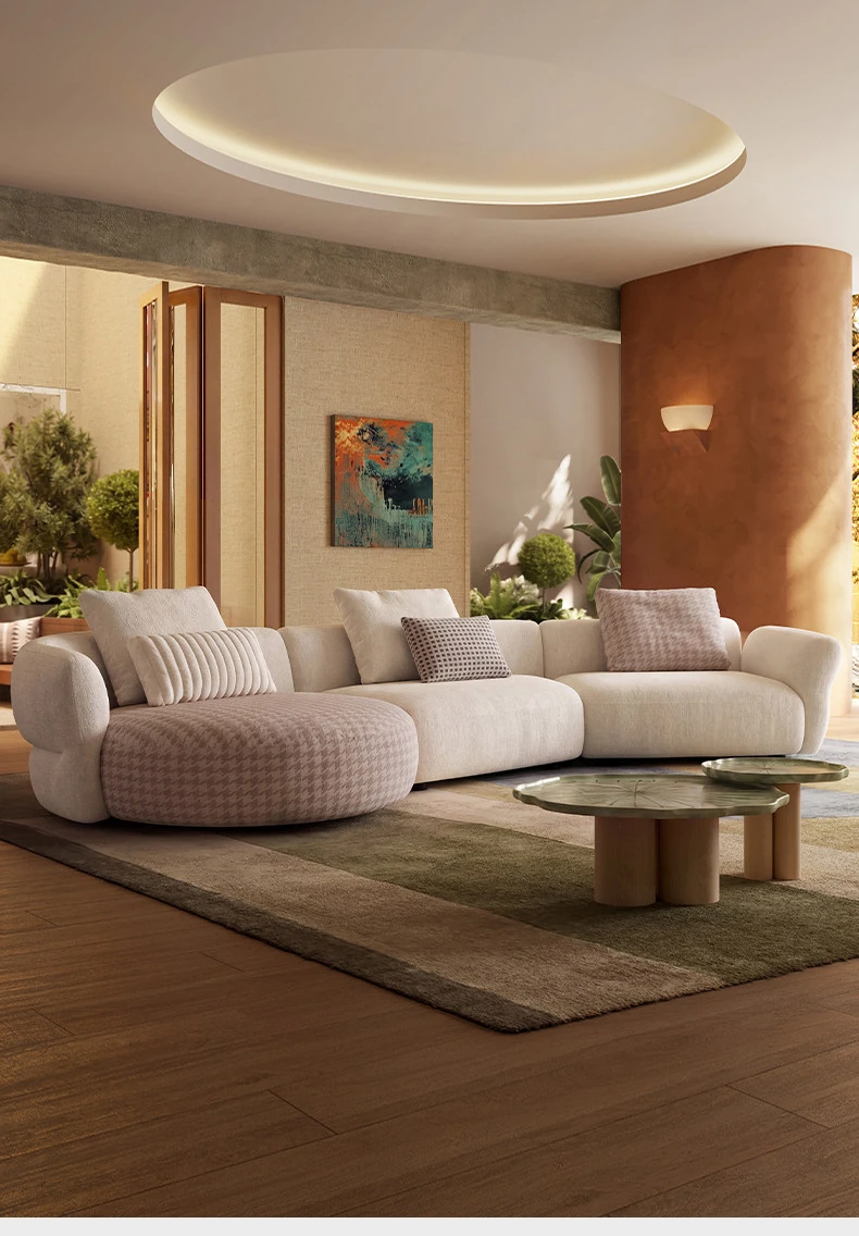 Curved cloud sofa with a round coffee table in a panelled living room